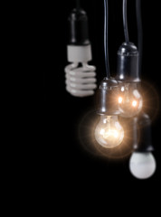 four hanging electric lamps isolated on black