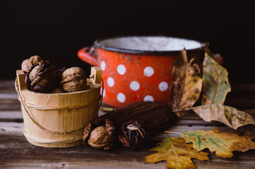 Walnuts on rustic table with old details on it. Autumn style.