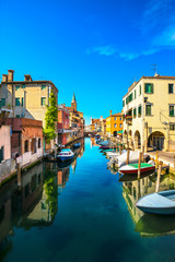 Fototapeta na wymiar Chioggia town in venetian lagoon, water canal and church. Veneto, Italy