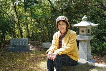 Elderly woman visiting the family grave