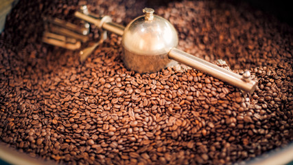 Coffee roasting, fresh coffee beans background