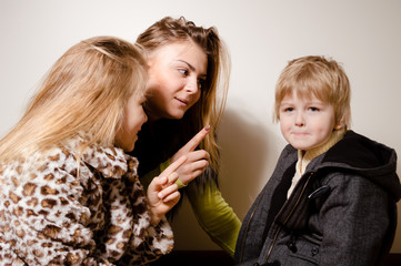 Portrait of adorable beautiful young family looking lovely in winter style clothing over light background. Healthy, emotional, peaceful joyful happiness lifestyle