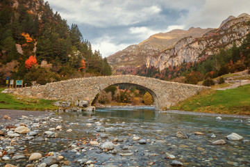 Romanesque bridge in the valley of Bujaruelo, XIII century on the Ara river, in the Aragonese Pyrenees, Huesca, Spain