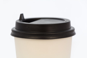 Closeup of disposable white cup on white background