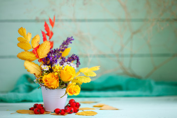 Autumn leaves and flowers on a wooden table. Autumn background with copy space. Autumn still life.