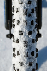 Snow-covered tire with tread
