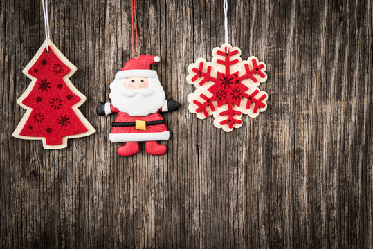 Red Christmas decorations over rustic wood