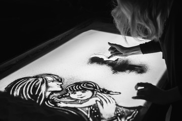 The woman draws on sand animation for mother's day