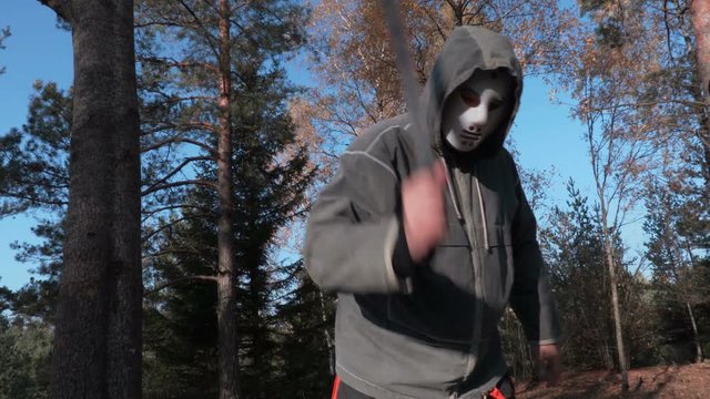 Man in scary Halloween mask using machete