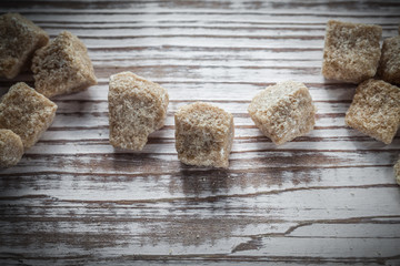 Vintage cane sugar cubes on wooden board