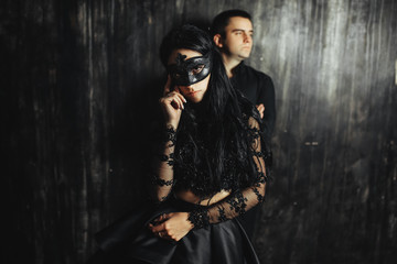woman  with  theatrical mask and handsome man