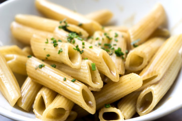 Pasta with pesto sauce and nuts on a the table