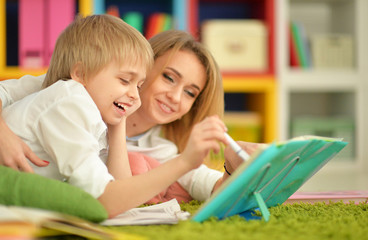 Obraz premium Mother with her son doing homework