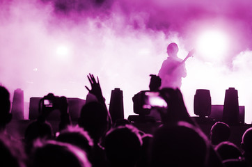 Obraz premium Concert Crowd. Silhouettes young people in front of bright stage lights. Band of rock stars