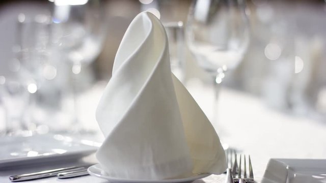 Shot of napkins on banquet table prepared for food serving at luxury Meliot restaurant