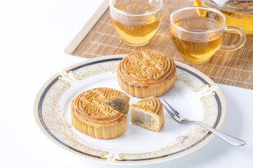 Moon cake and tea - Chinese mid-autumn festival food on white background.