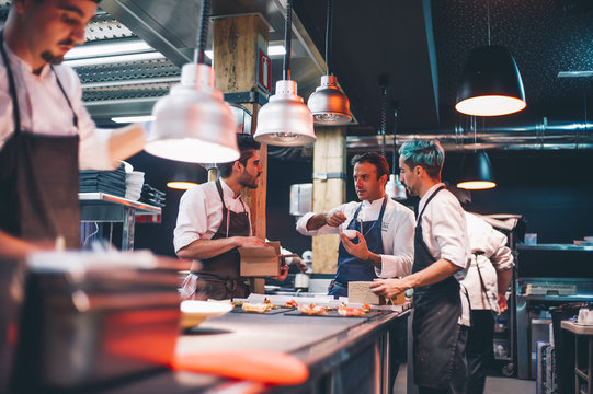 Chef cooking instructing cooks.