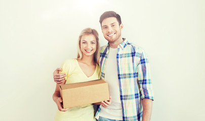 Fototapeta na wymiar smiling couple with box moving to new home