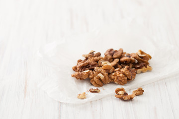 Fototapeta na wymiar Walnuts peeled nuts on a white table