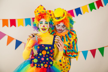 a terrible clown and a good clown. Halloween. The crazy clown and clowness.