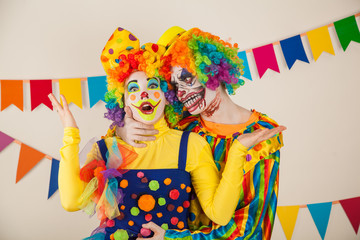 a terrible clown and a good clown. Halloween. The crazy clown and clowness.
