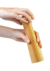 Wooden pepper mill in hands isolated on white background.