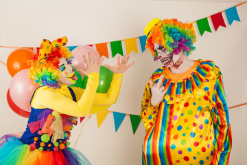 a terrible clown and a good clown. Halloween. The crazy clown and clowness.