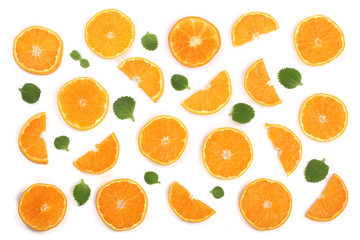 Slices of orange or tangerine with mint leaves isolated on white background. Flat lay, top view. Fruit composition