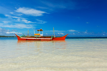 Fototapeta premium Traditional fishing boat on pristine beach
