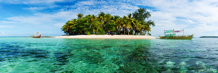 Tropical Guyam Island with traditional fishing boats