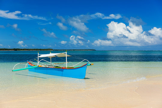Traditional fishing boat on pristine beach