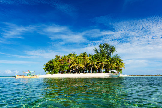Tropical Guyam Island with traditional fishing boats