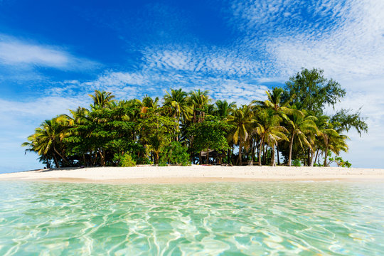 Tropical Guyam Island with traditional fishing boats