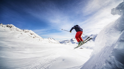 Fototapeta na wymiar Extreme skier jumping off the cliff