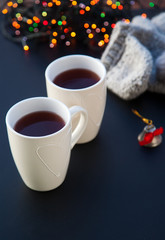 hot tea in white cup and Christmas decorations - cozy winter day