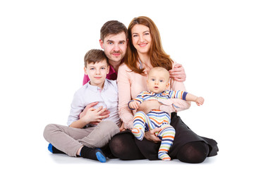 Happy Family with child and baby on a white background isolated, sitting on the floor - Concept of happy family