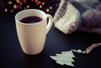 hot tea in white cup and Christmas decorations - cozy winter day