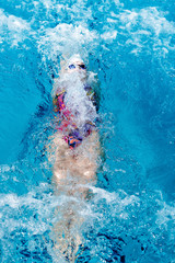 woman swimming with swimming hat in swimming pool