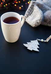 hot tea in white cup and Christmas decorations - cozy winter day