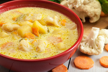 Vegetable soup with ingredients carrot, cauliflower, potato and parsley