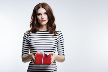 Gorgeous auburn-haired woman holding a gift box