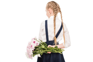child holding bouquet of flowers