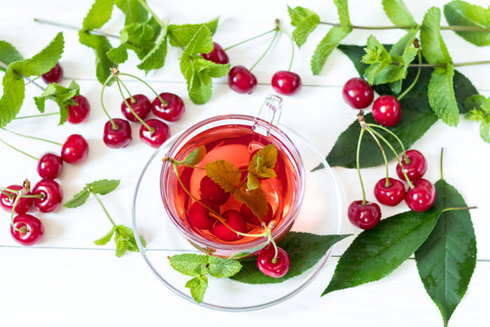 Fruit cherry drink in transparent glass cup