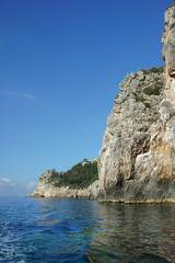 Steep rocky cliffs on the coast of Corfu island, Greece. © valerijs