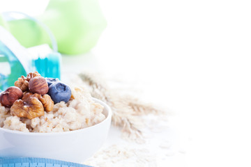 Delicious oatmeal porridge with berries and nuts