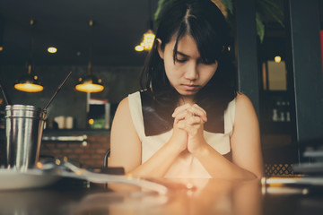 woman praying in morning. Hands folded in prayer