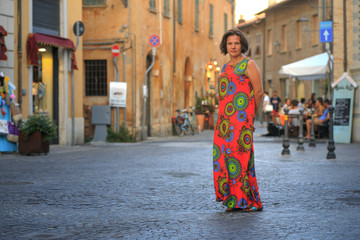 Naklejka premium girl in red dress on the street in italy.