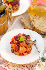 Russian traditional vegetable salad Vinegret with beetroots, pot