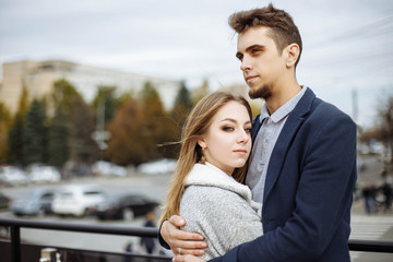 Loving couple embracing while walking the city street. Dating and love concept.