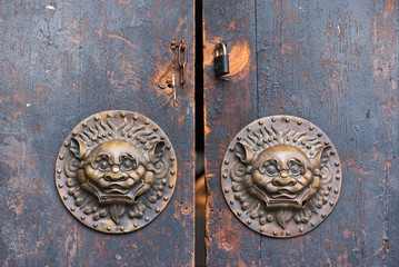 Old brown chinese traditional wooden gate with Lion door knockers, China